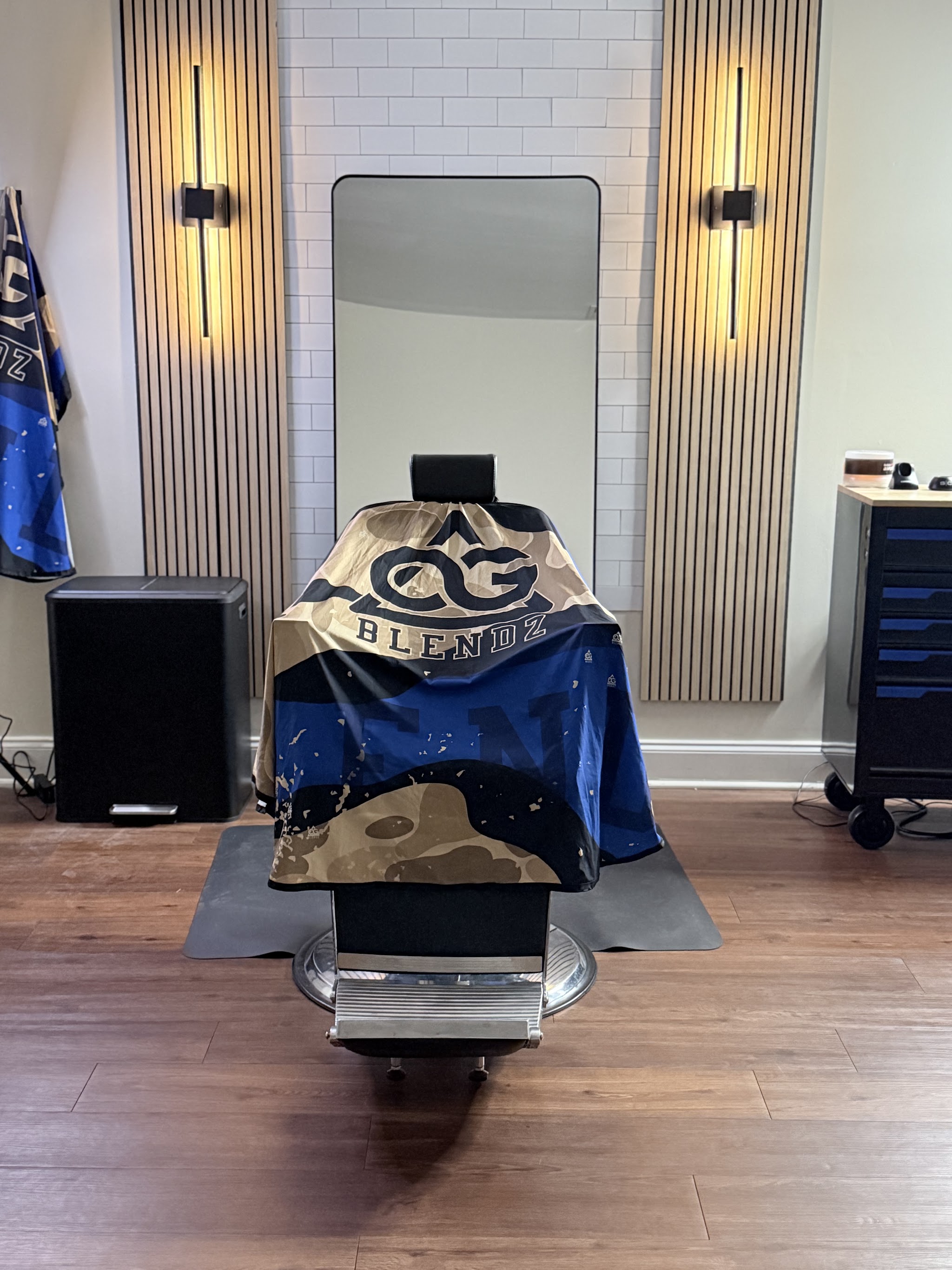My chair at OG Blendz Studio, with the OG Blendz cape and wood slat wall