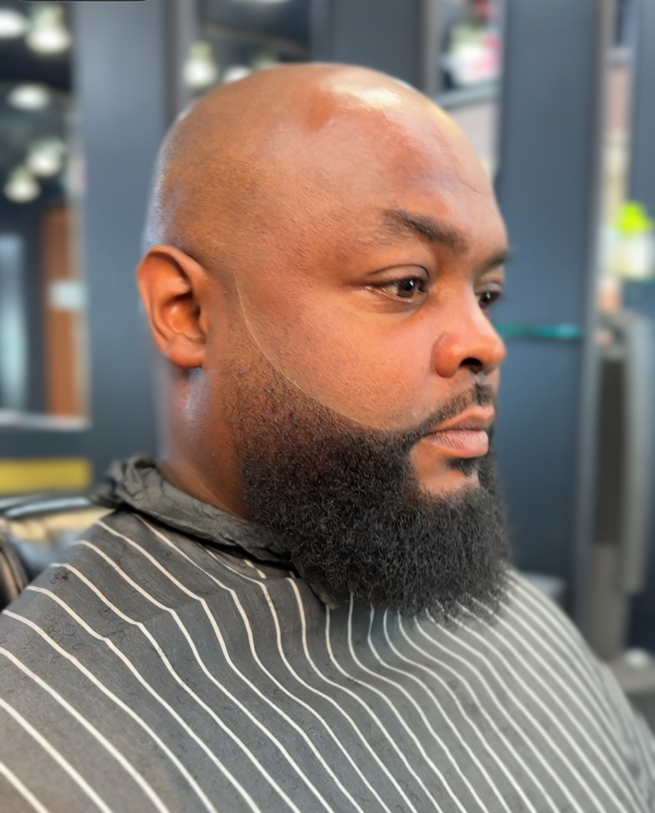 Bald head and full, sharply lined beard
