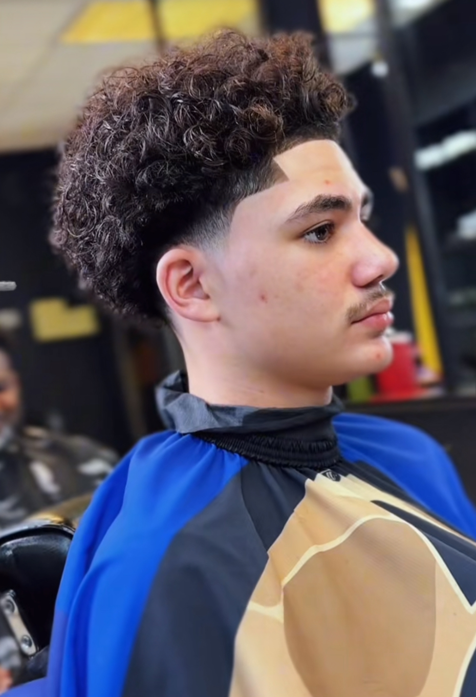Skin fade on a teen with a tapered top